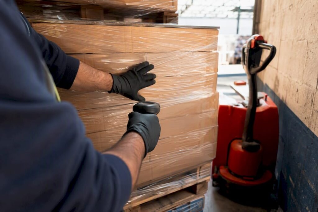 Worker inspecting pallet at dock